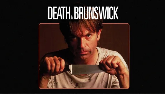 Movie poster for Death in Brunswick featuring Sam Neill holding a large kitchen knife, with the film title displayed above.